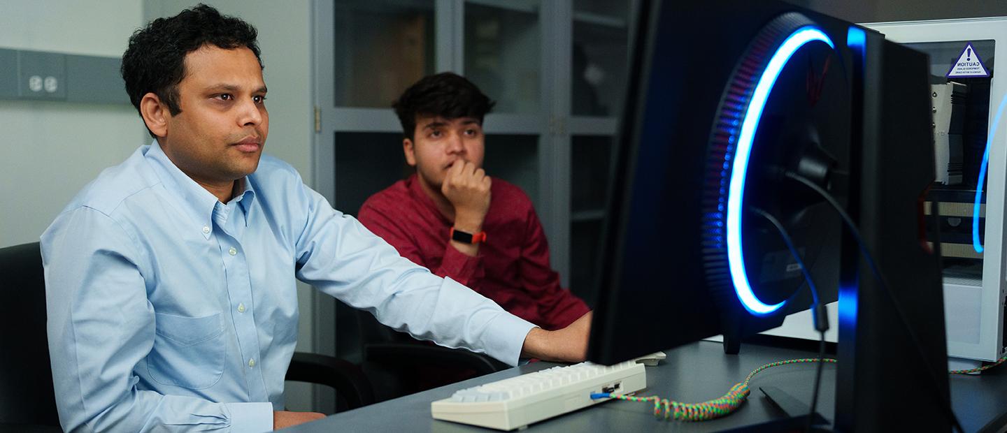 Two men working at a computer